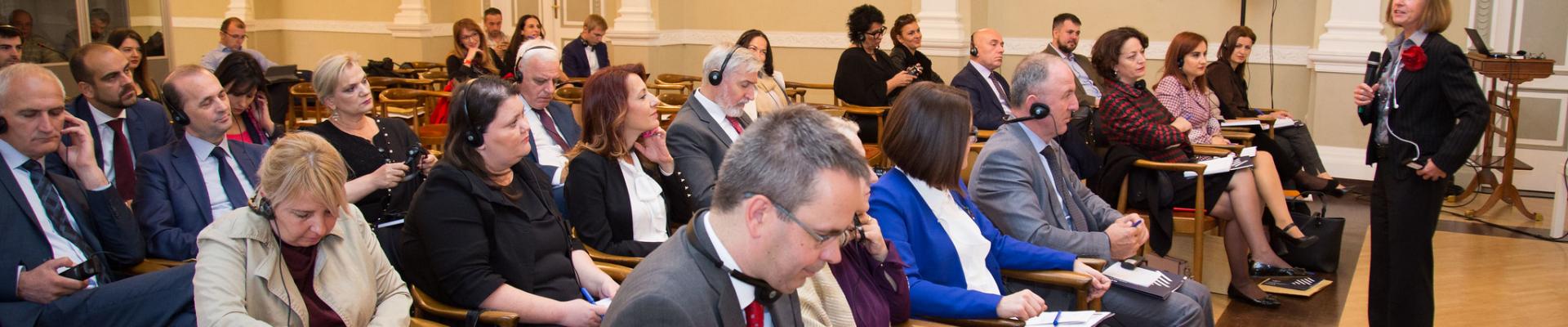 People listening to a WFD representative speak at a conference