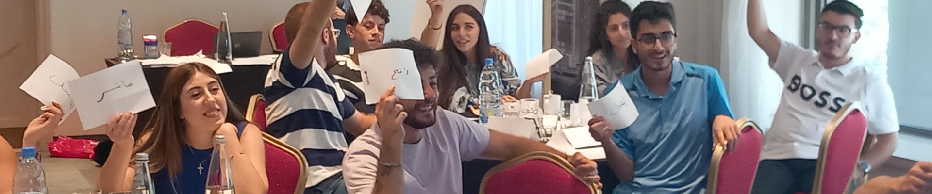 Youth in Lebanon lifting papers in a meeting