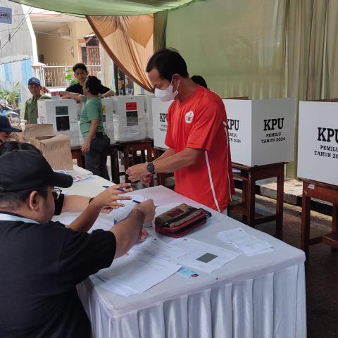 A picture of polling booth with election officials working during elections in Indonesia