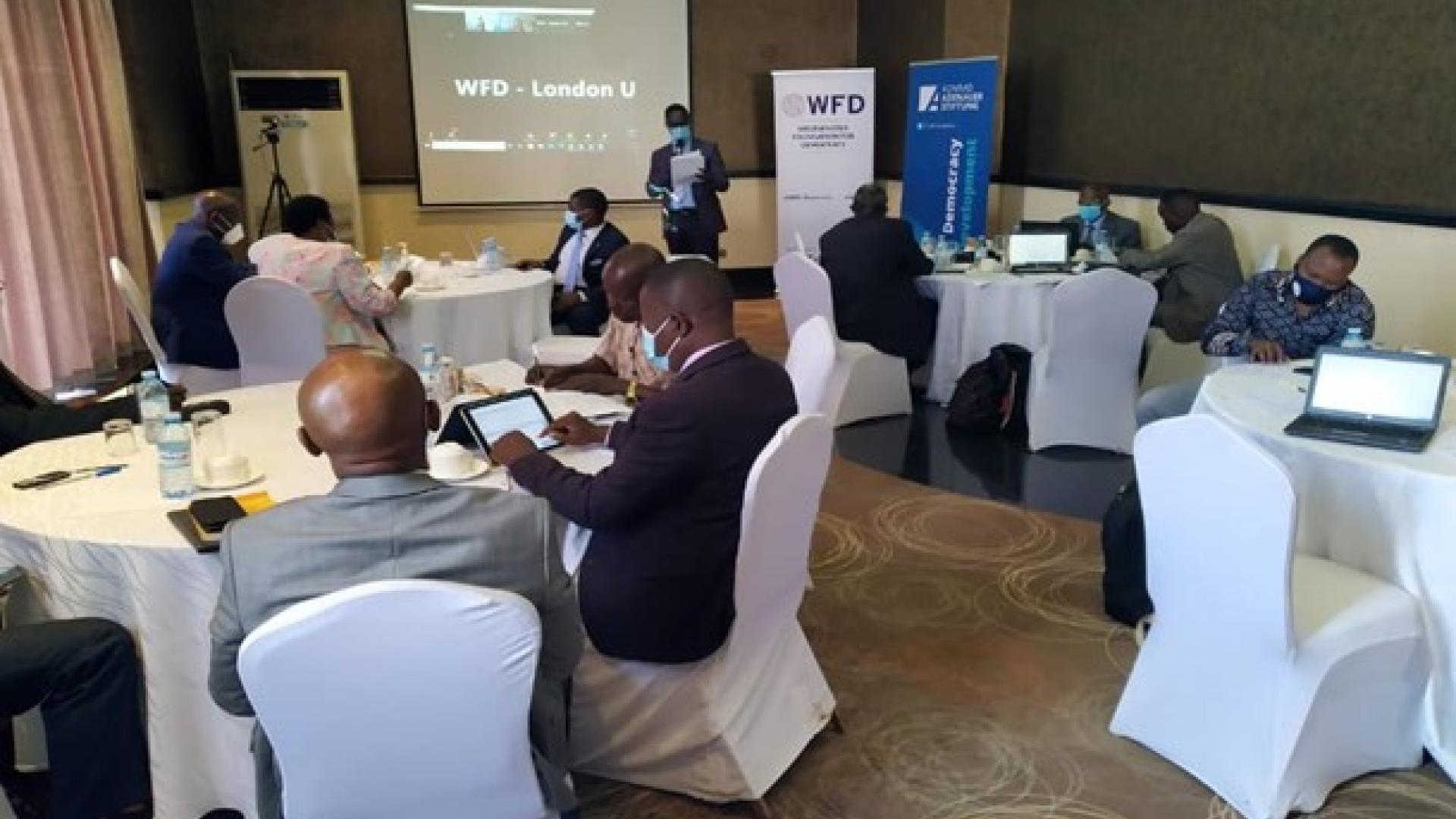 Stakeholders sitting round tables at a meeting