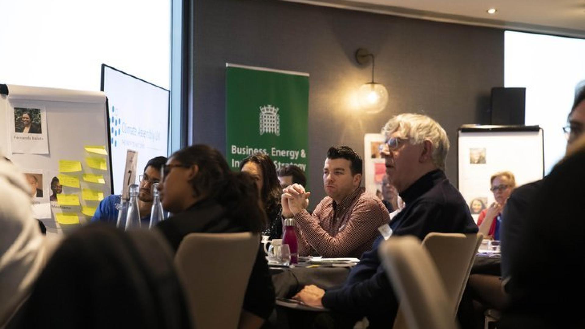 Participants in the Climate Assembly UK sitting at tables