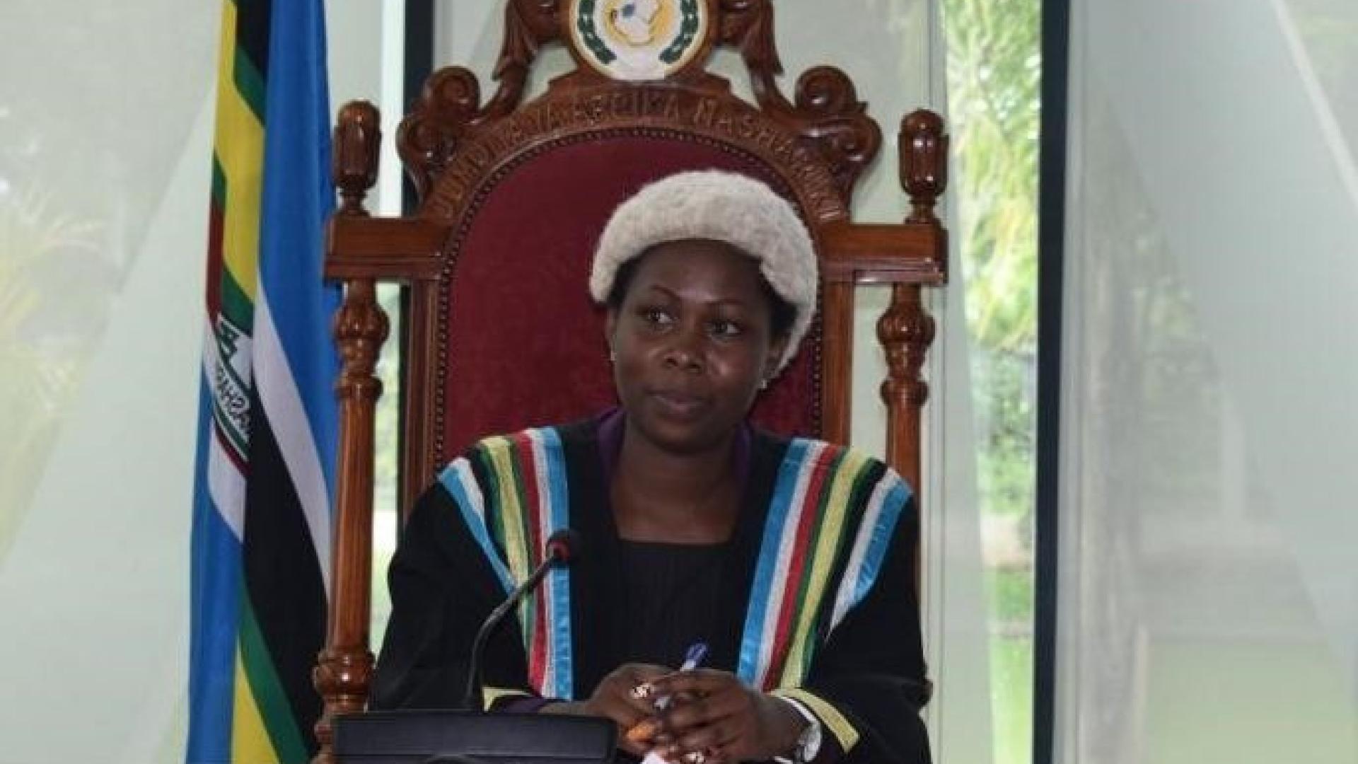 A woman sitting wearing parliamentary leadership robes