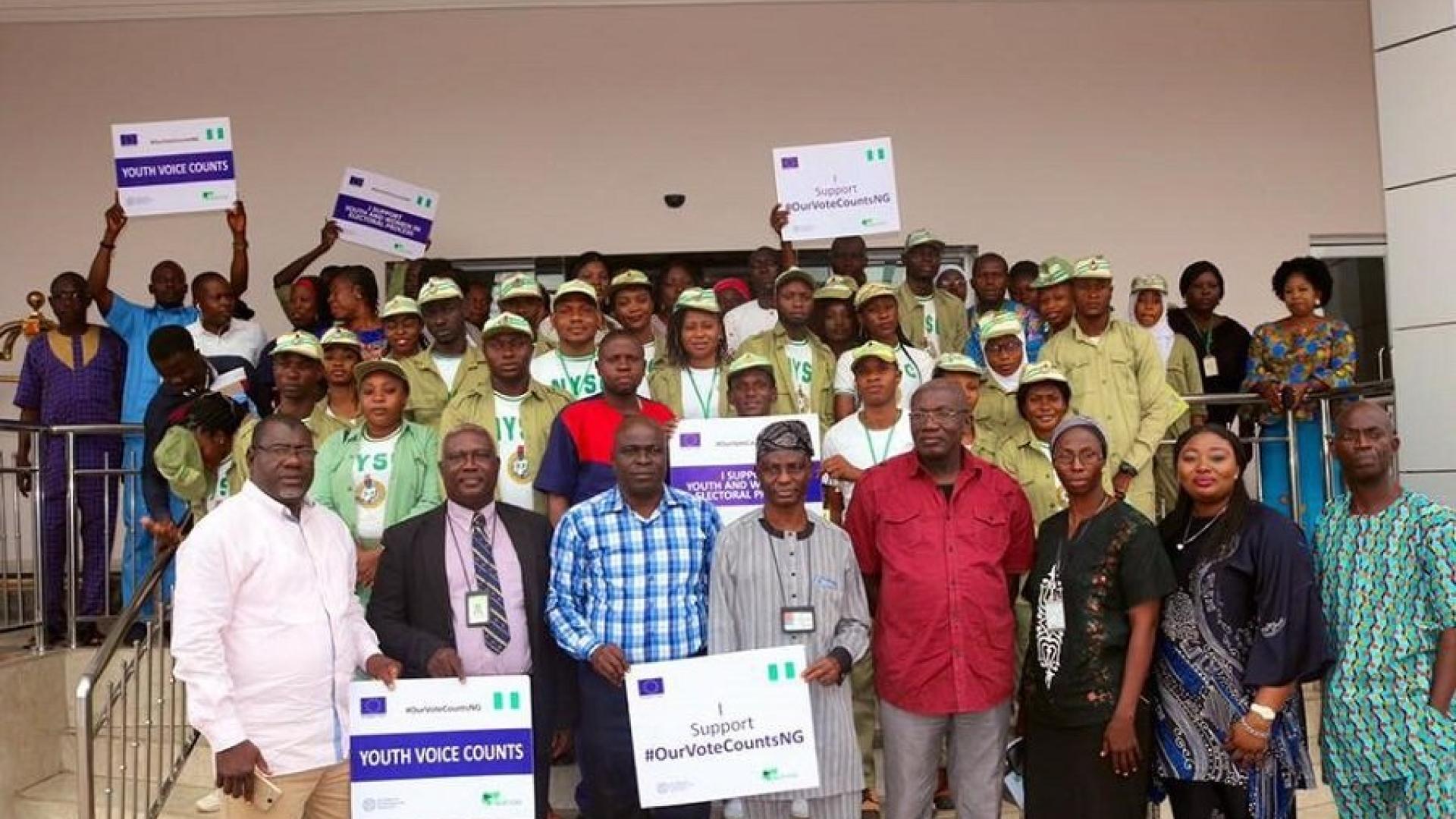 Group of people with some holding placards 