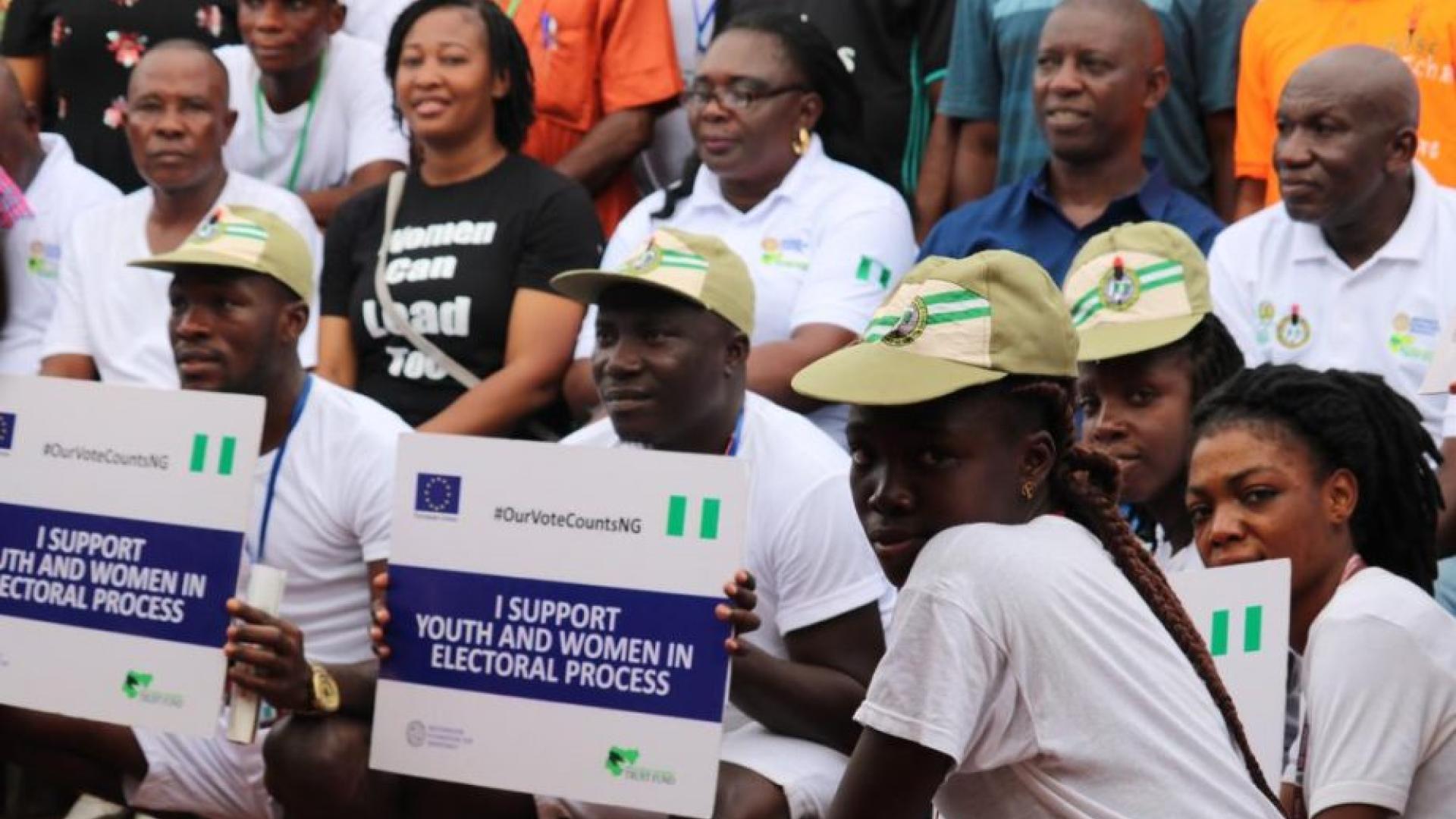 A group of people with some holding placards 