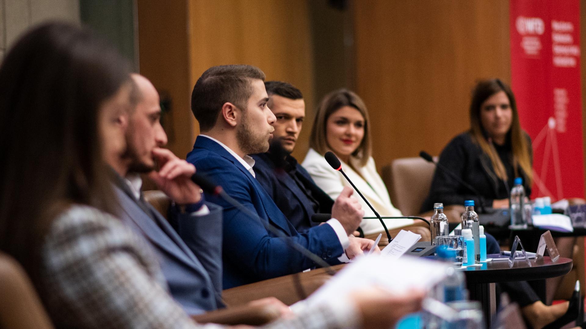 Young man speaking at a conference