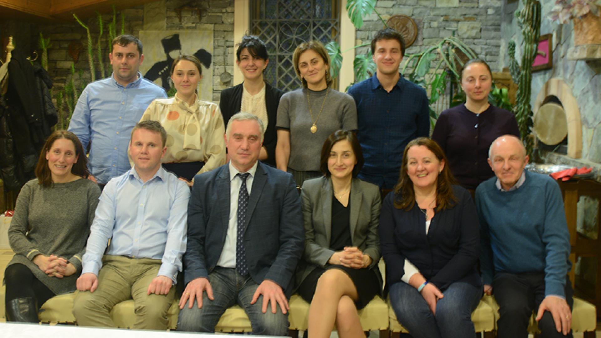 A group of people sitting and looking at the camera