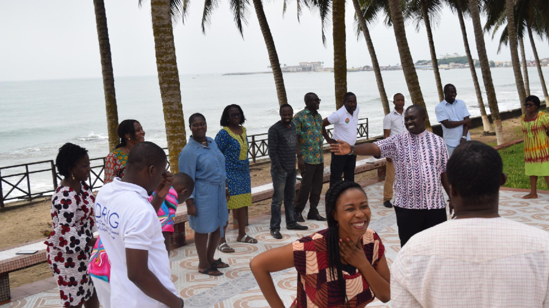 People standing by the beach talking