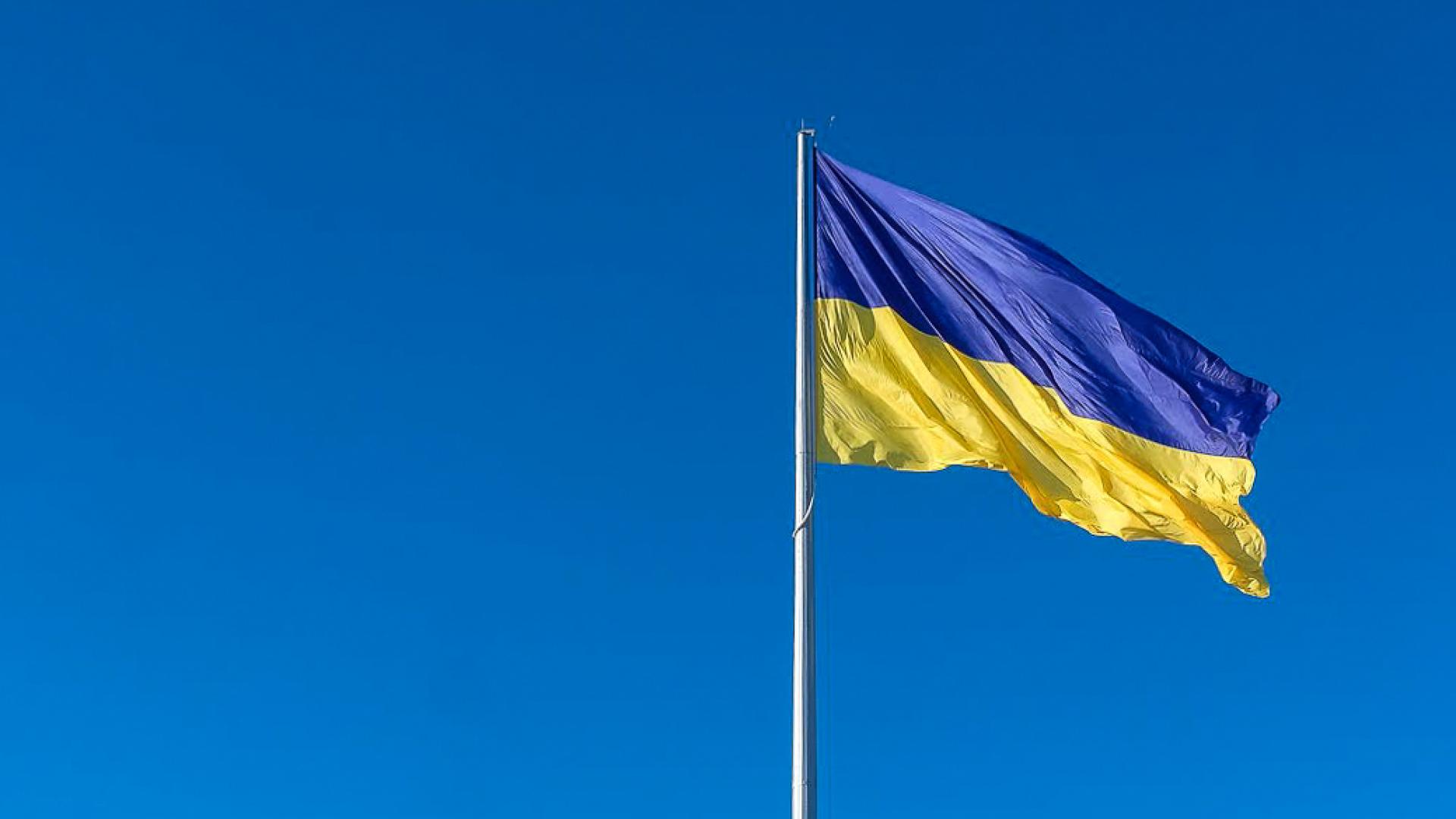 Flag of Ukraine flying against a clear blue sky