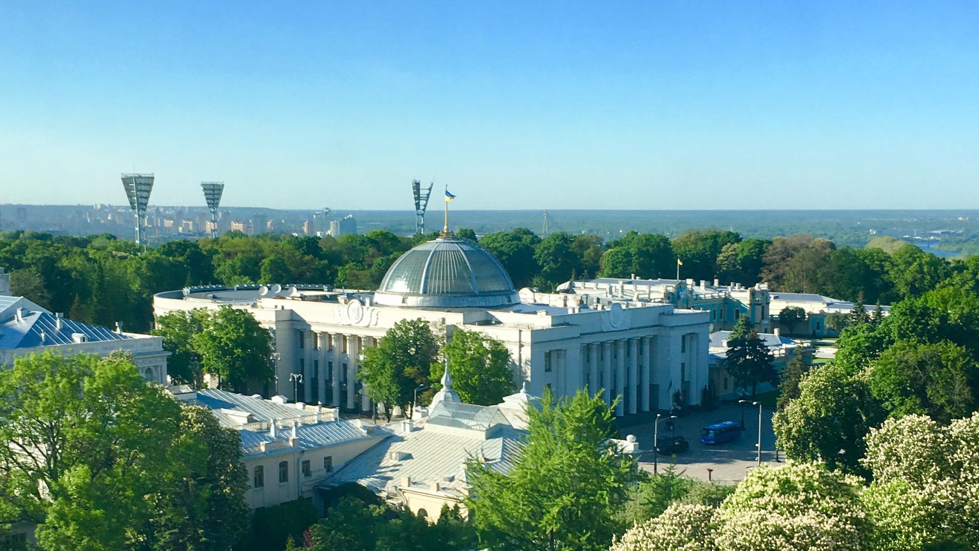 The Verkhovna Rada of Ukraine with the Ukrainian flag flying above the dome on a sunny day