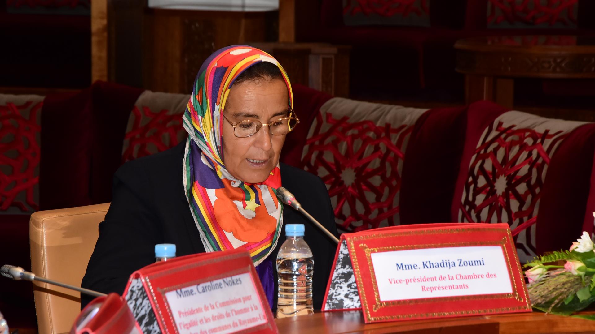 A woman leader speaking on a mic