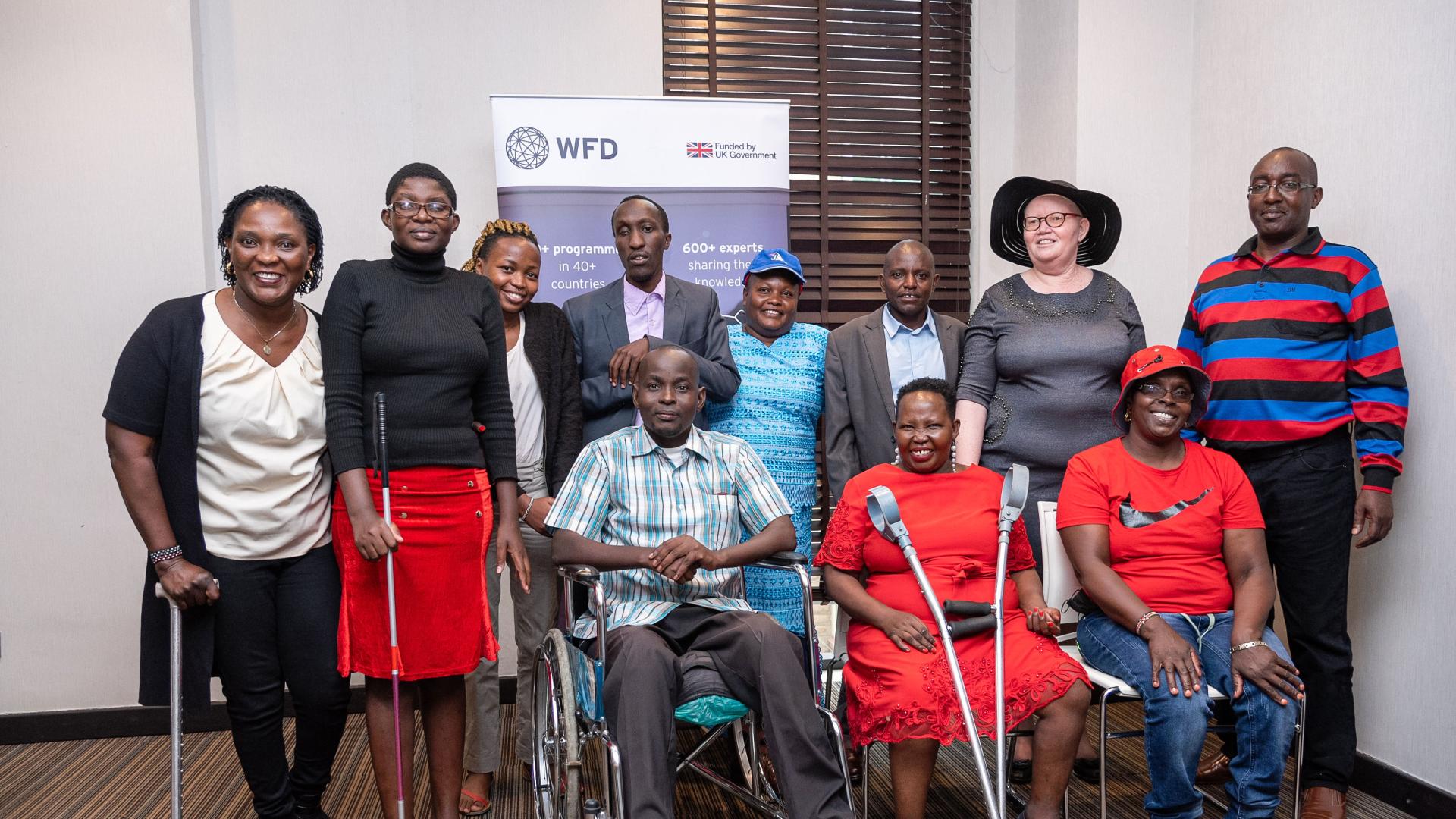 People posing by sitting and standing