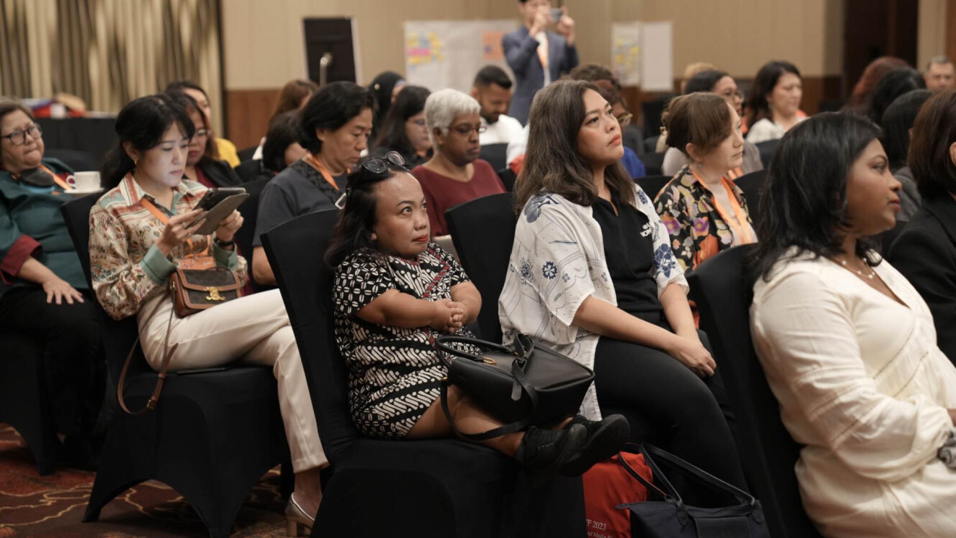 Audience members listen attentively