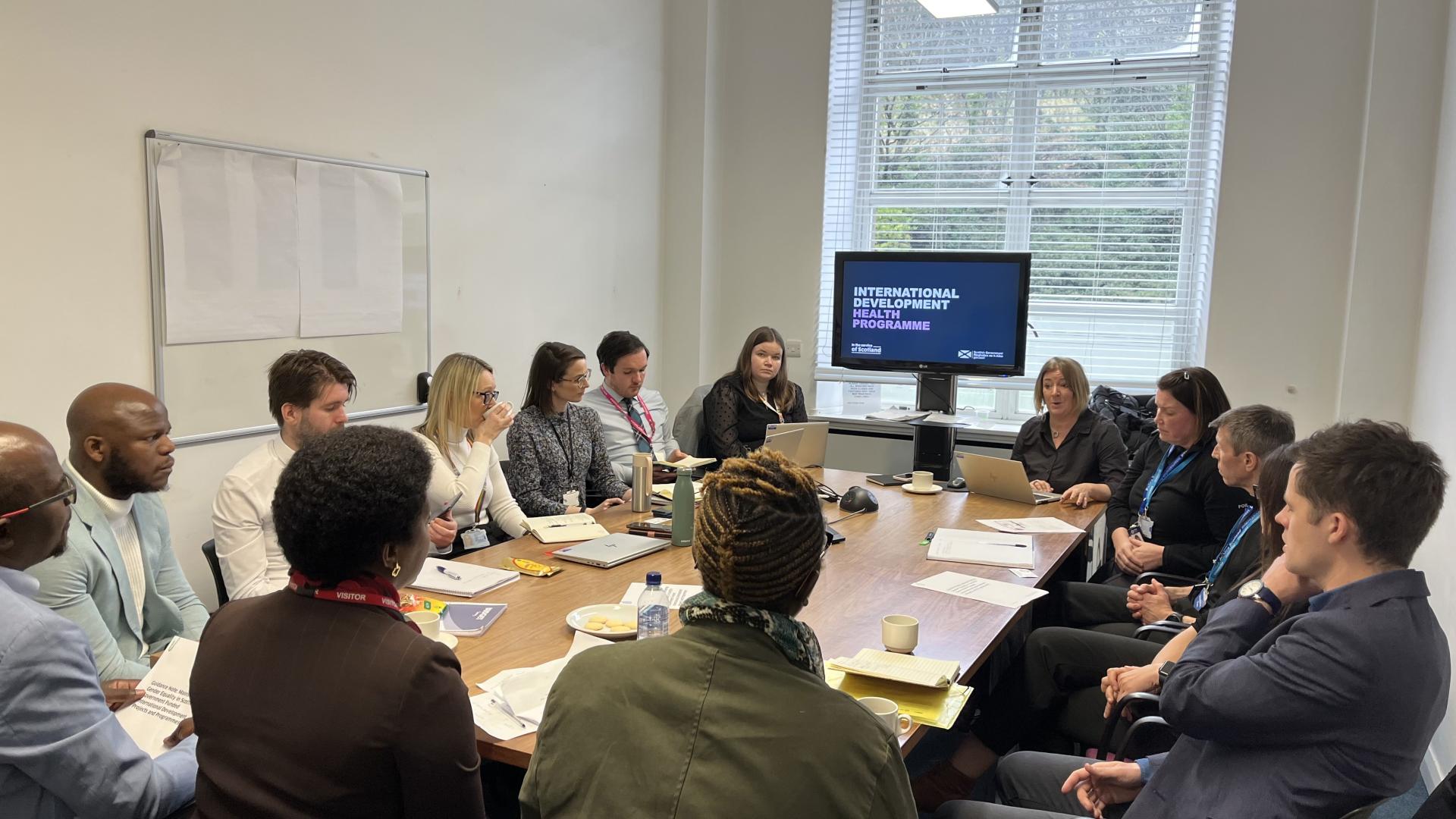 People sitting around a table in a meeting