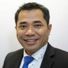 Indonesia Country Representative Agus Wijayanto smiling at the camera