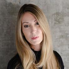 A woman with long hair looking at the camera